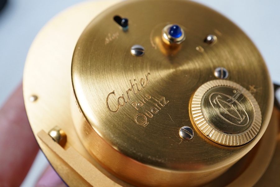 A modern Cartier gilt metal quartz travelling clock. 9cm. Condition - good, not tested as working